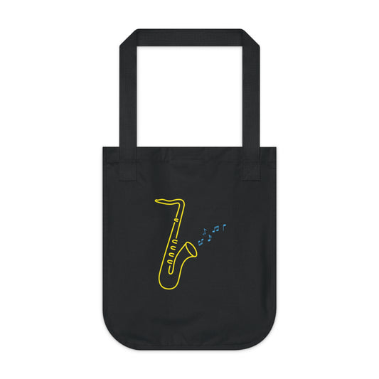 Black Organic Tote Bag with a vibrant neon design of a yellow saxophone and blue musical notes, from the TEQNEON Music Box and Accessories collections