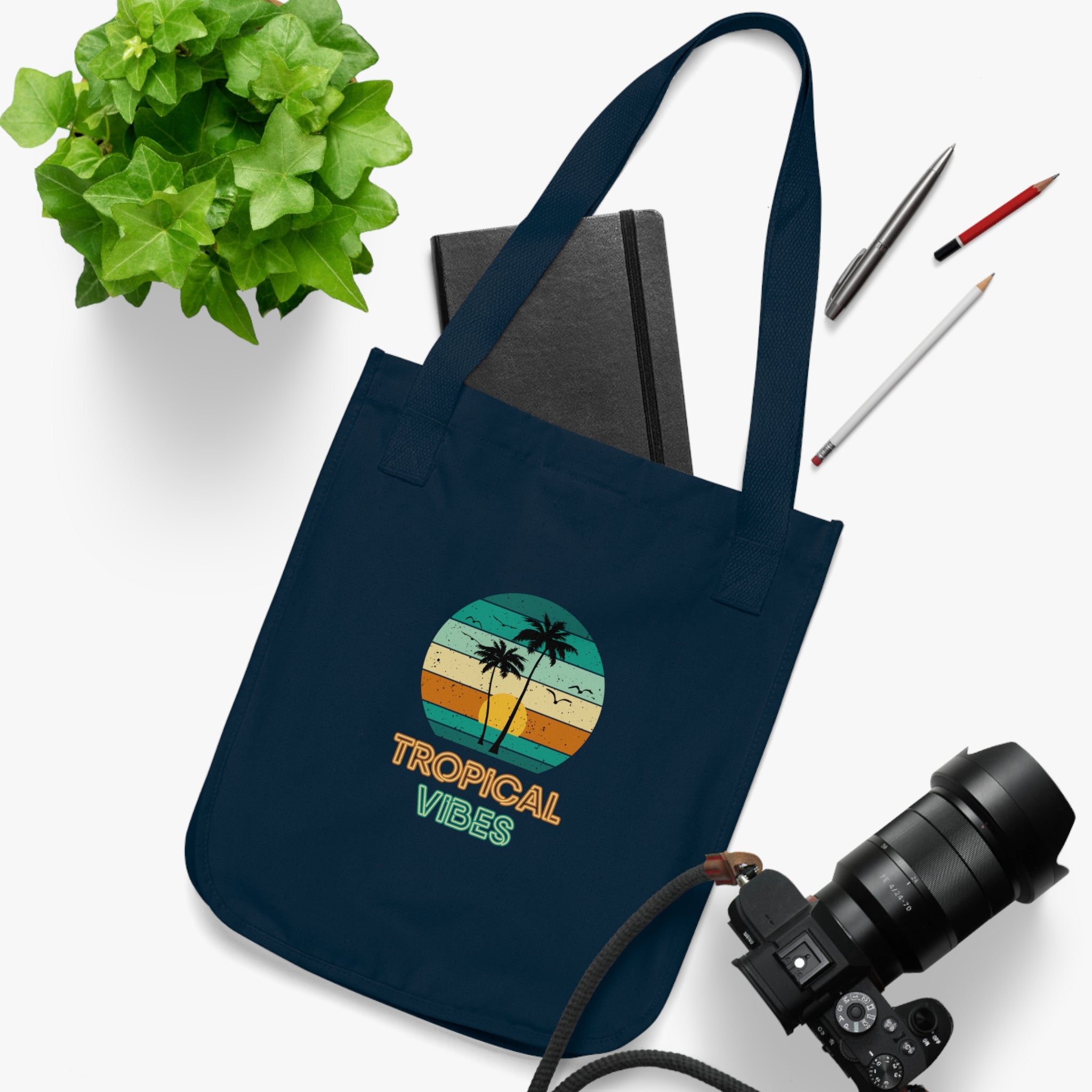 Navy organic canvas tote bag with multi coloured tropical beach design and neon font stating 'Tropical Vibes'. Taken from the TEQNEON Word Craft and Accessories collections