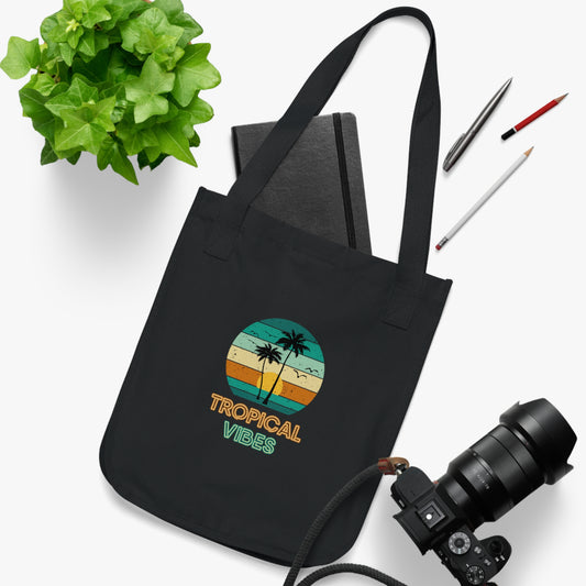 Black organic canvas tote bag with multi coloured tropical beach design and neon font stating 'Tropical Vibes'. Taken from the TEQNEON Word Craft and Accessories collections
