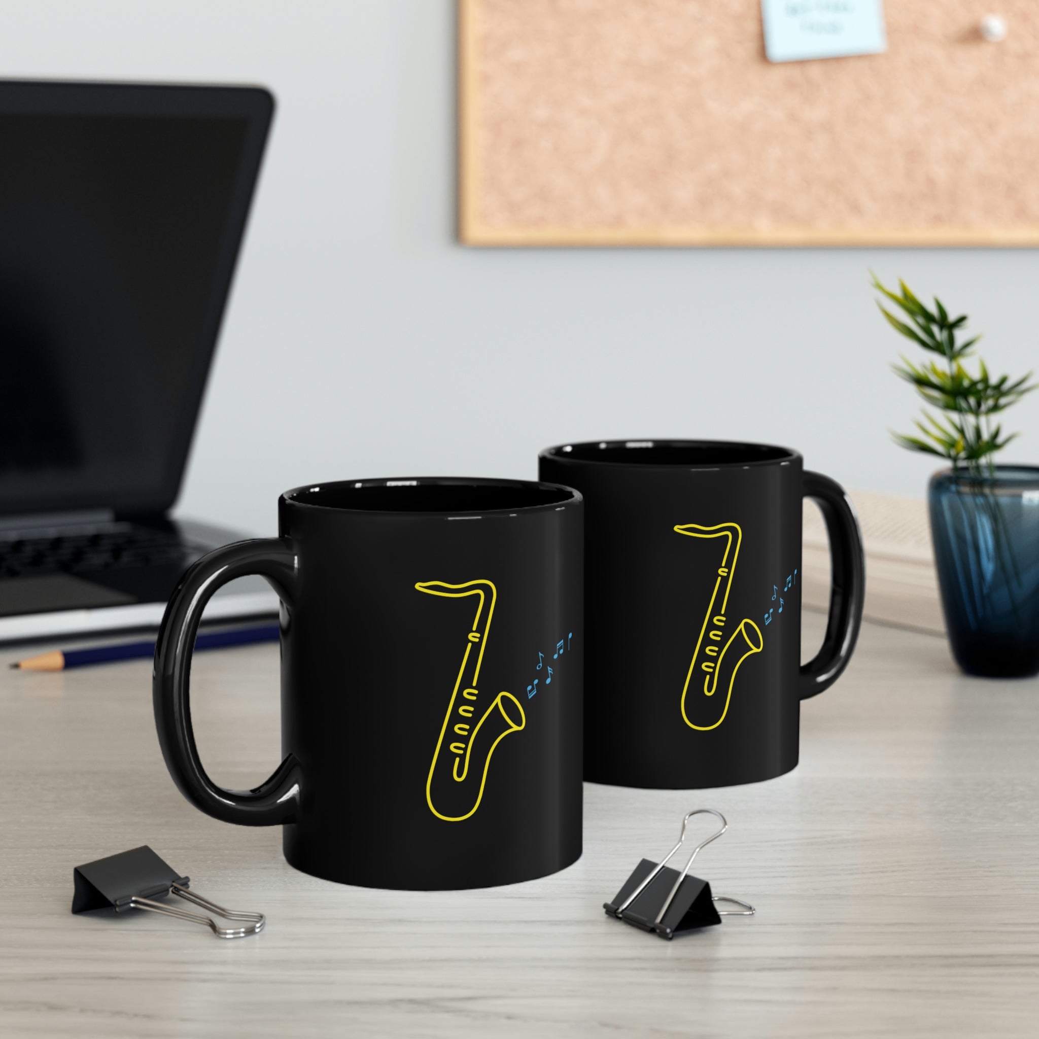 Black Mug with a vibrant neon design of a yellow saxophone and blue musical notes, from the TEQNEON Music Box and Accessories collections