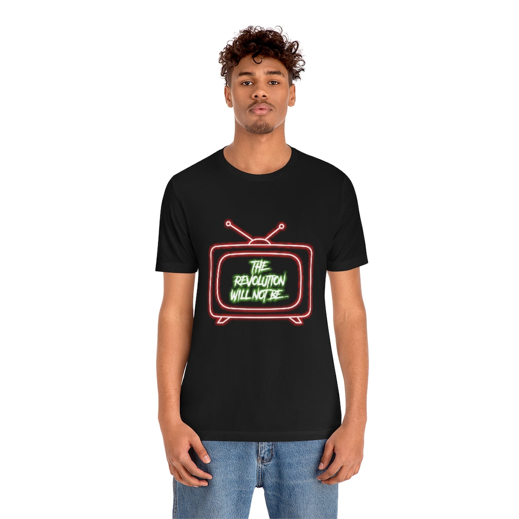 Black T-Shirt with a bold white and green text proclaiming 'The Revolution Will Not Be...' inside a red neon-styled television. From the TEQNEON Word Craft collection